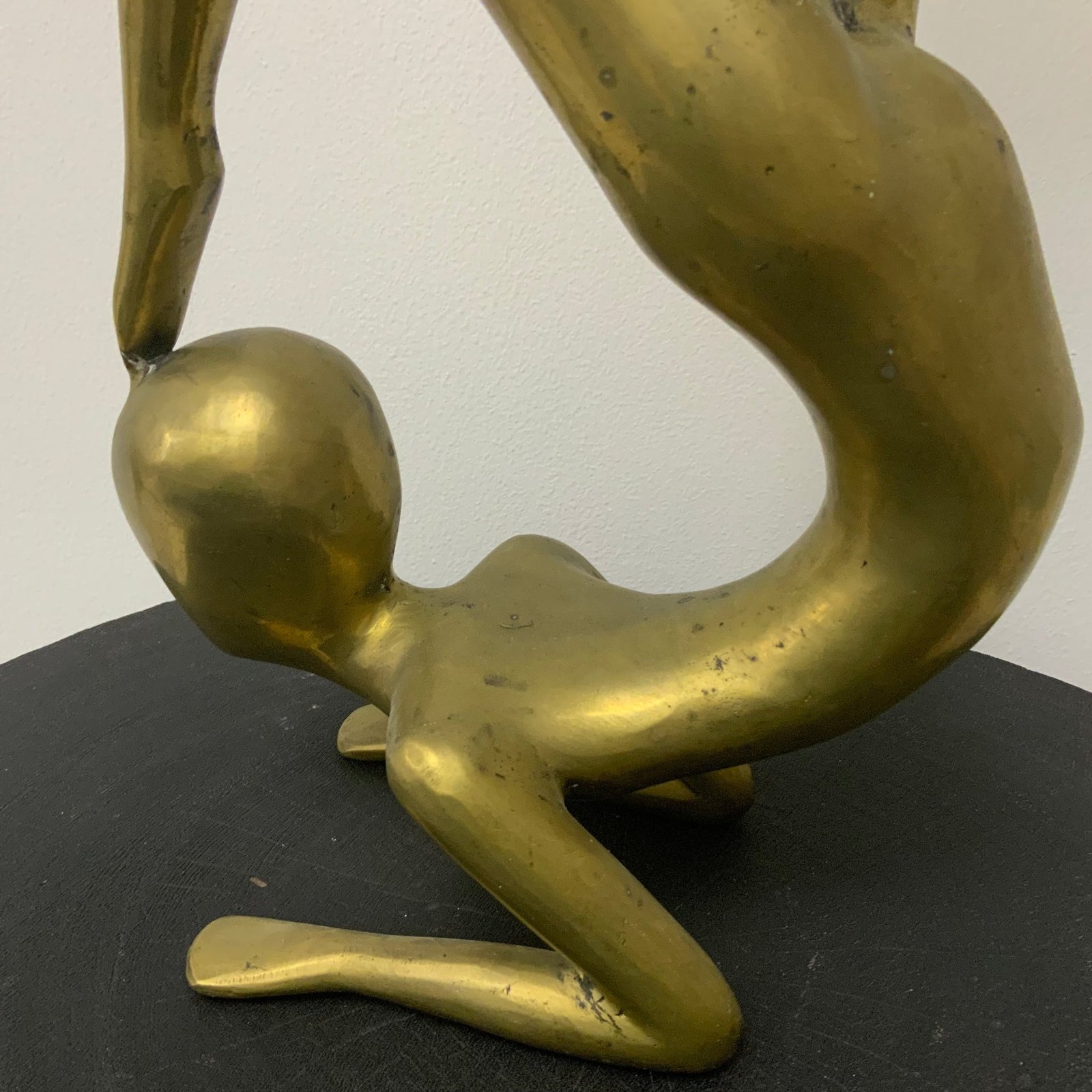 Vintage solid brass candlestick holder shaped like a contortionist gymnast in a chin-stand pose, balancing a candle dish on one raised foot
